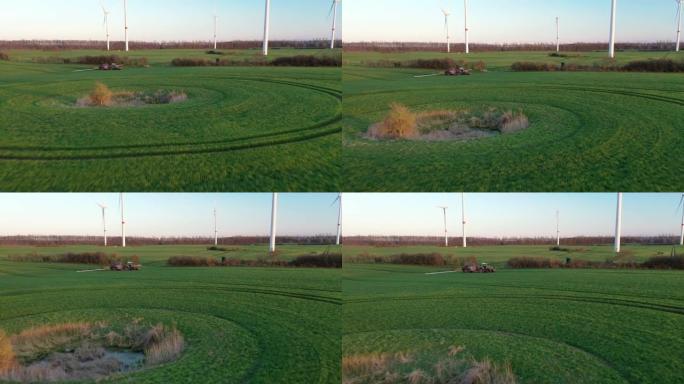 用杀虫剂喷洒农田的航拍画面。防止风电场附近农业领域的害虫。农业和风能联合生产的航拍画面。