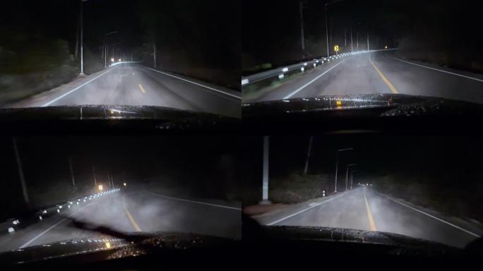 夜间在非常小的雨下，在乡村公路上从车内行驶的场景，烟雾蒸汽，挡风玻璃刮水器