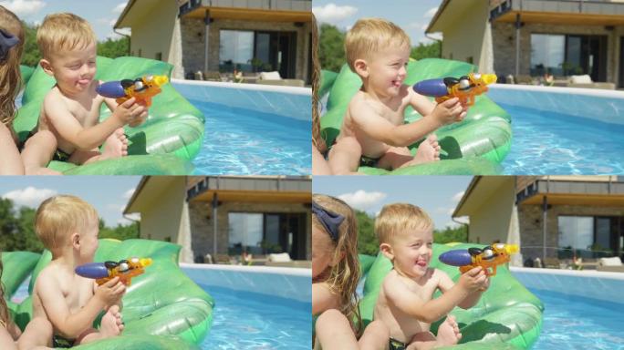 特写: 微笑可爱的小男孩在花园游泳池里玩水枪