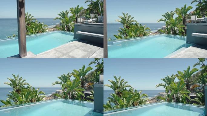 豪华酒店美丽的游泳池，阳光明媚的日子里可以看到海洋异国度假胜地目的地，棕榈树暑假旅行4k