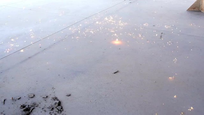 焊接火花簇在地面慢动作上爆发。