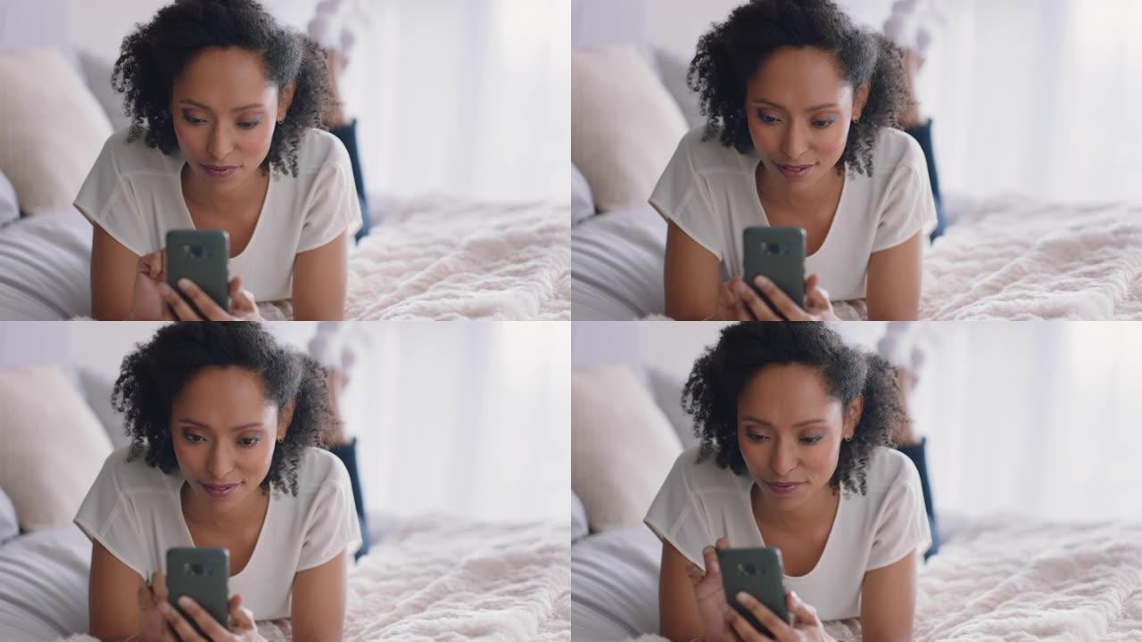 美女使用智能手机短信浏览社交媒体信息享受手机通信躺在家里的床上