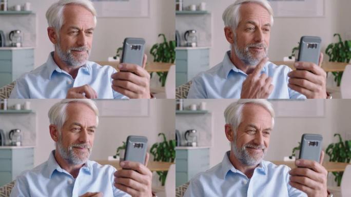 聋人手持智能手机进行视频聊天，使用手语祖父挥舞着享受手机上的连接聊天