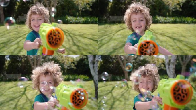 快乐的小男孩吹肥皂泡在阳光明媚的花园里玩玩具枪享受有趣的游戏有趣的顽皮的孩子享受夏天4k