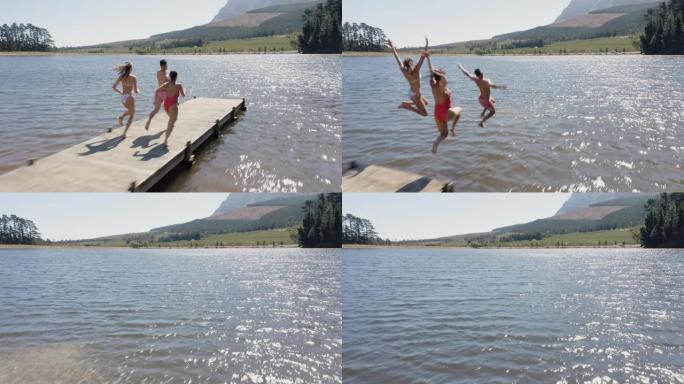 鸟瞰图快乐的朋友在湖边跳下码头，玩得开心，在暑假享受自由，头顶无人机