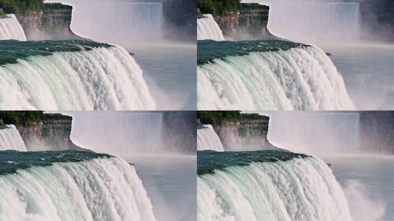 尼亚加拉大瀑布迅速流下，在背景中你可以看到加拿大海岸的瀑布。美国和加拿大的著名地标