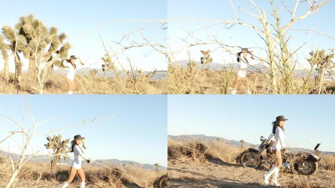 沙漠中的性感女人骑着摩托车行走