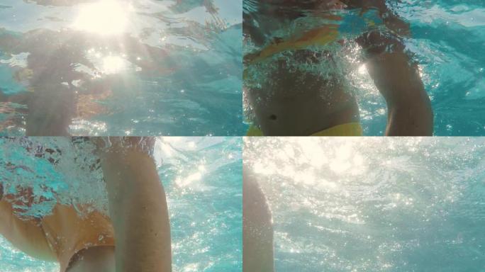 赤膊男子在游泳池游泳的水下视图，美丽的阳光照耀着水中的光线4k