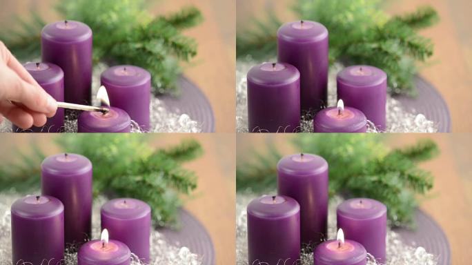 一根紫色蜡烛燃烧和花环的降临