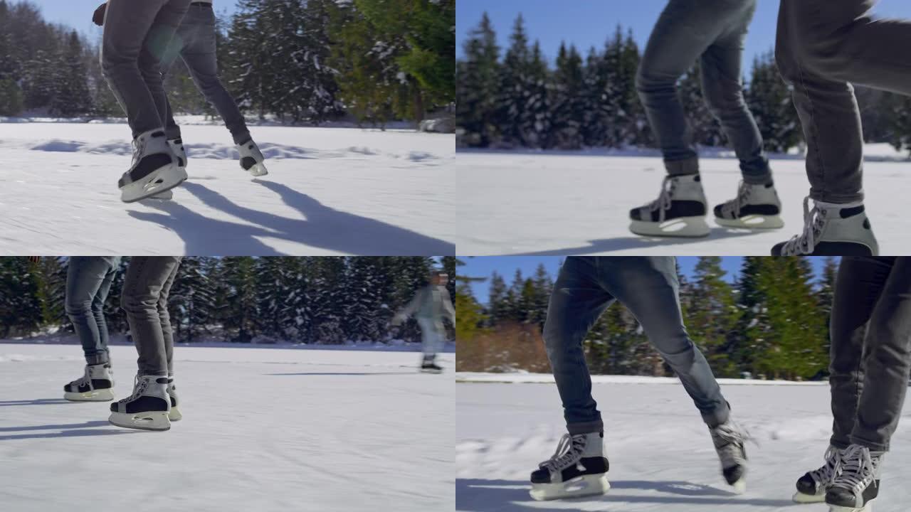 TS两人的腿在阳光下的冰冻湖上滑冰