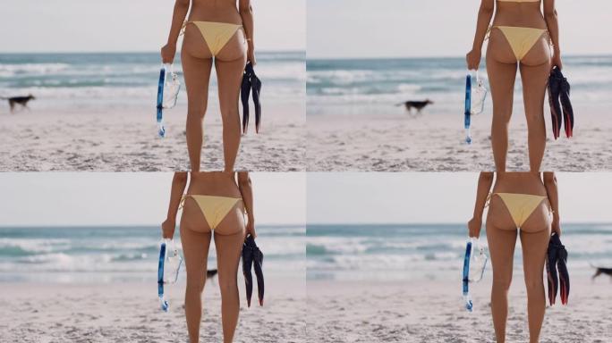 靠近美丽的女人走在海滩上，拿着通气管和脚蹼准备游泳，在地中海享受温暖的暑假