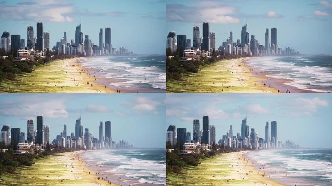 黄金海岸天际线和豪华建筑的时间流逝城市景观，人群在澳大利亚昆士兰州伯利角黄金海岸北伯利郊区的伯利海滩
