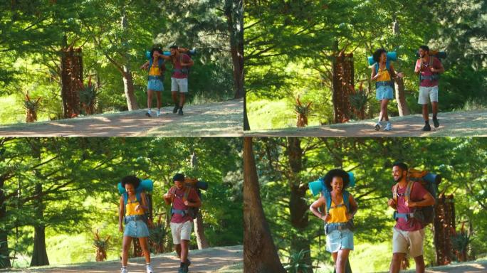 背着背包的情侣在假期一起徒步穿越乡村时互相击掌