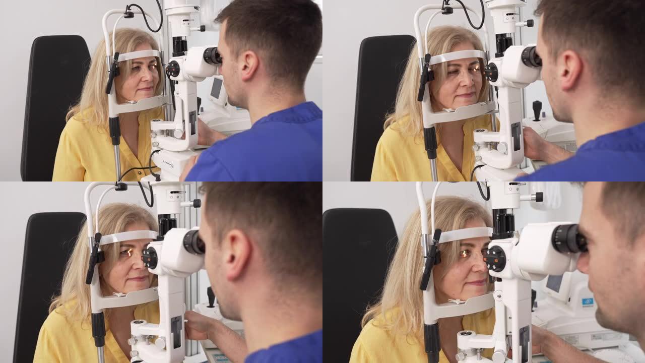 在诊所，男性眼科医生用裂隙灯检查一名高级女性患者的眼睛结构