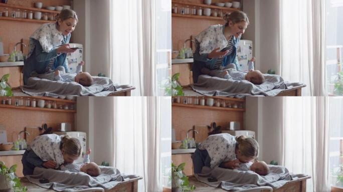 快乐的母亲用智能手机给婴儿拍照，享受在社交媒体上分享母亲生活方式的可爱幼儿拍照