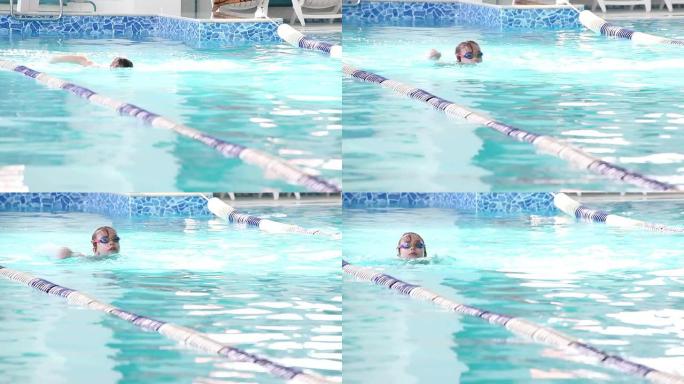 小女孩在游泳池里游泳。