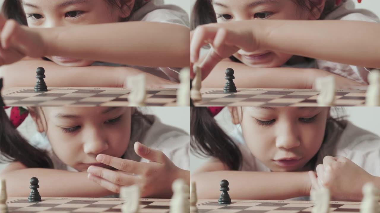 可爱的亚洲小女孩在明亮的白色房间里玩棋盘游戏，阳光普照，展示了战略规划、创造力和儿童教育决策的概念。