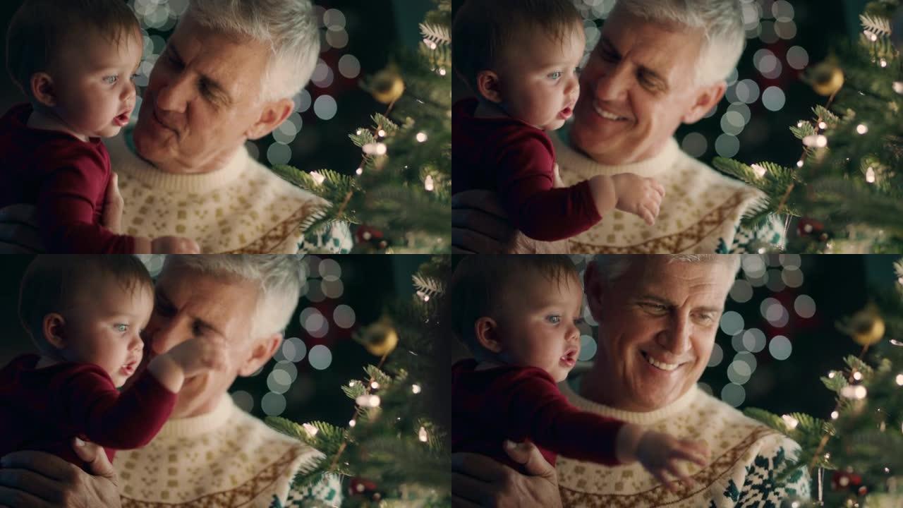 爷爷带着婴儿装饰圣诞树，用漂亮的装饰品和小玩意学步的孩子帮助爷爷在平静的夜晚在家中悬挂节日装饰品4k