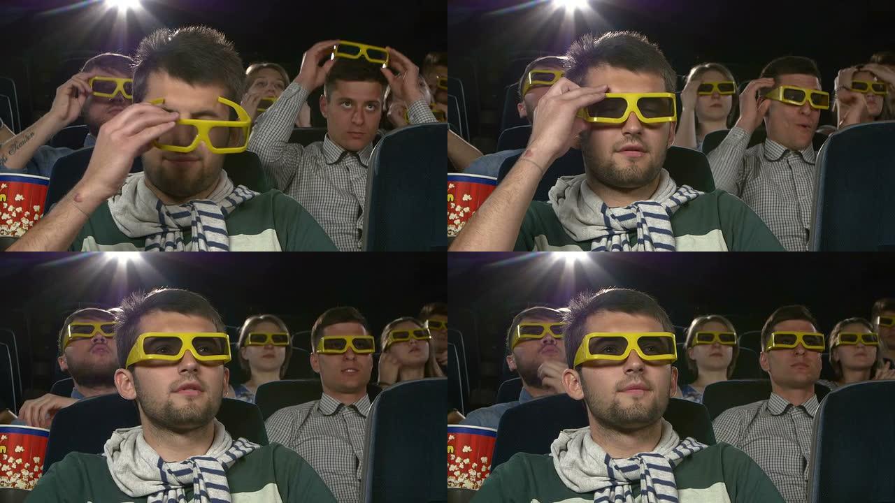 年轻人戴3D眼镜到电影院看电影