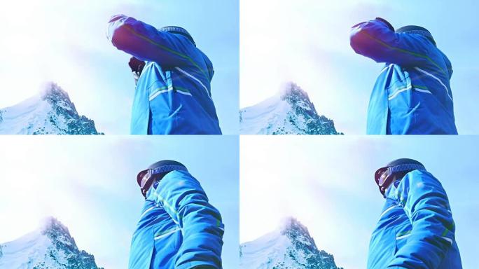 男滑雪者将眼镜放在蓝天上的低角度视图