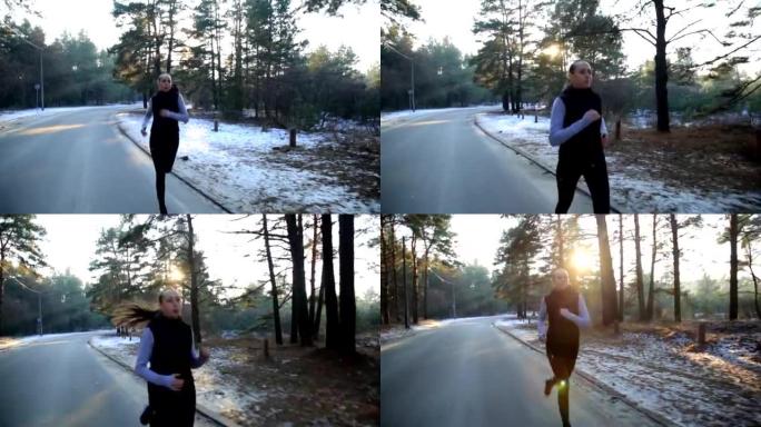 身材苗条的年轻女子在日出时从事体操。她沿着森林跑步