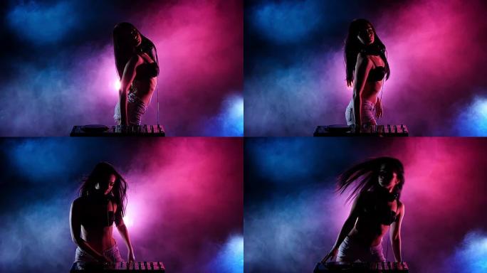 DJ女孩用她的身体做性感的波浪运动。慢动作。剪影