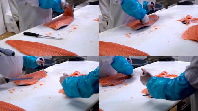 男人在鱼店的餐桌上切鲑鱼片。多莉开枪