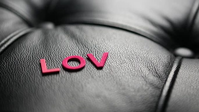 “爱” 一词的字母出现在黑色皮革上