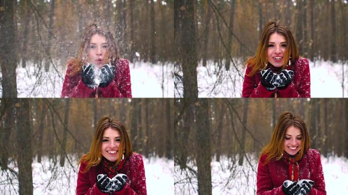 美丽的年轻微笑的冬季女孩在野外吹雪超慢动作120fps