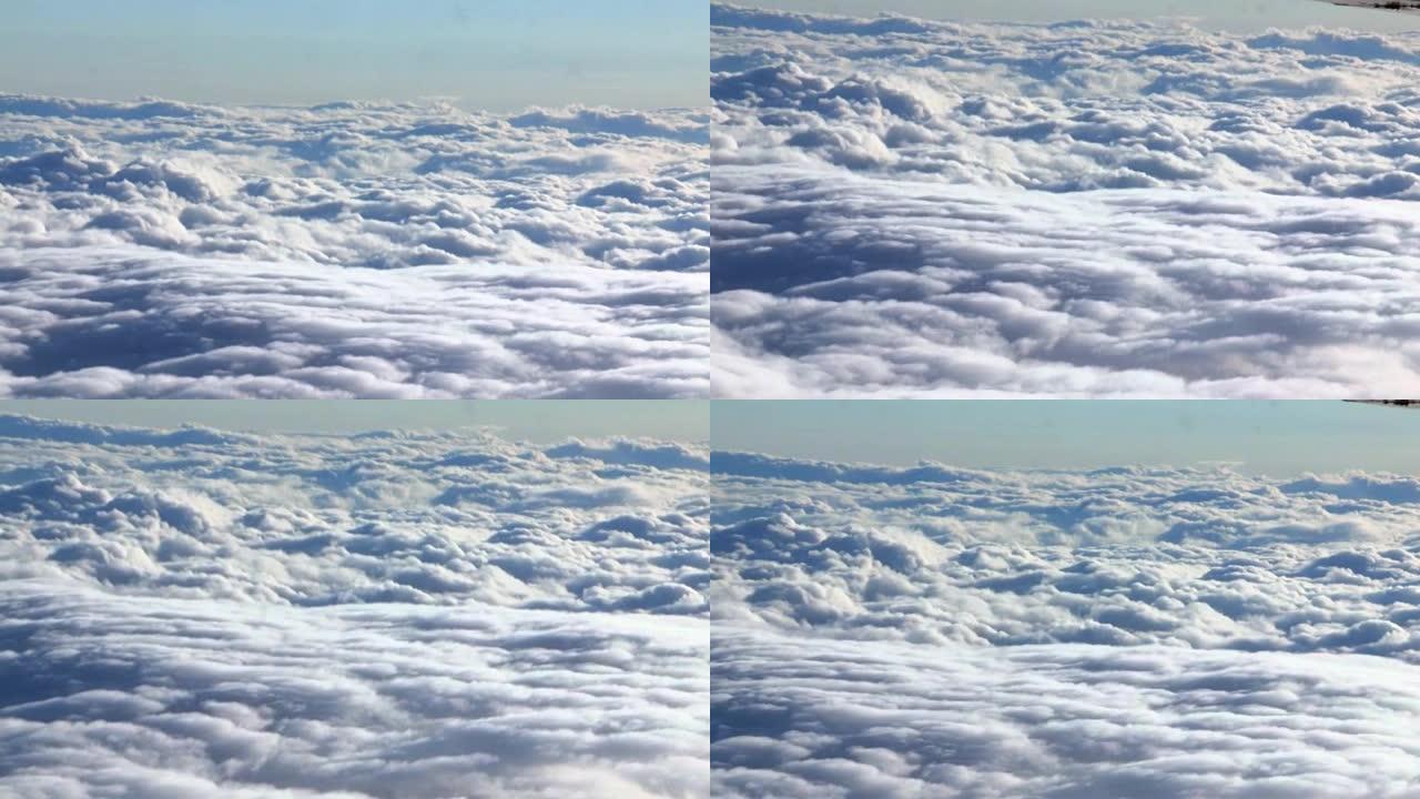 飞过云层。从平面视图看美丽的蓝云