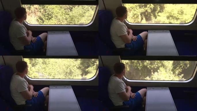 戴着耳机的年轻人看着窗外的火车