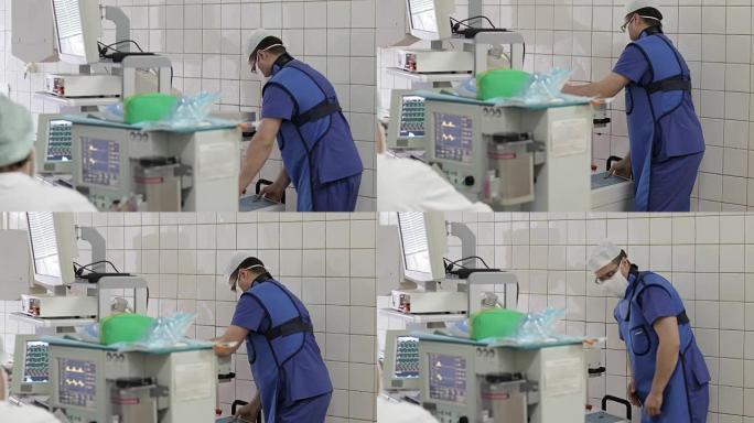 4k一名身穿制服的年轻医生在手术室移动医用x光设备。