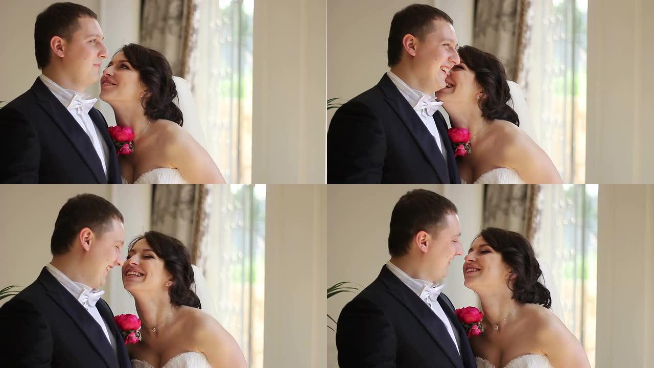 婚礼情侣接吻和大笑