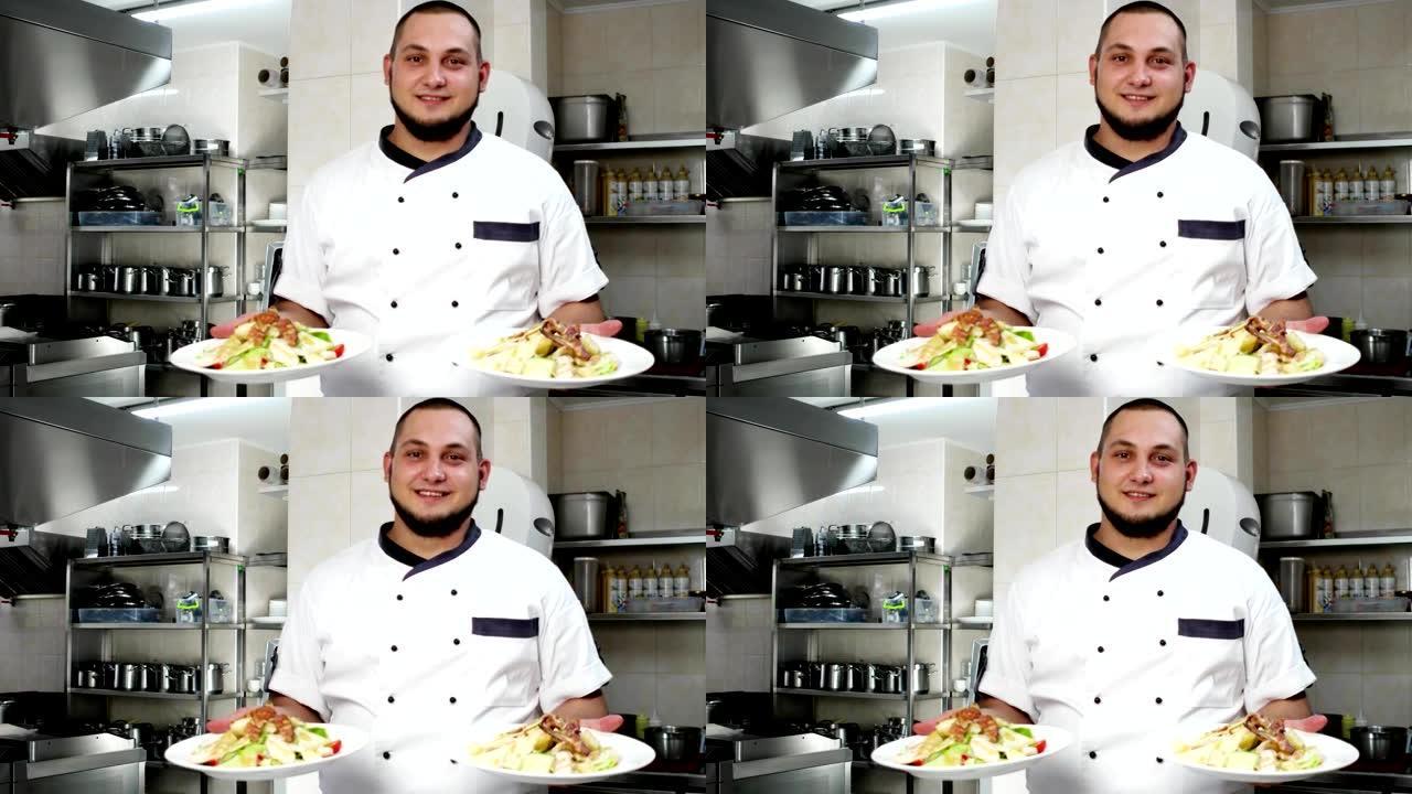 厨师的肖像，厨师拿着沙拉的菜肴，现成的饭菜表演，看着相机，微笑着厨师在专业厨房