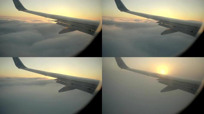 飞机减少并从窗户看到Cunrise进入云层