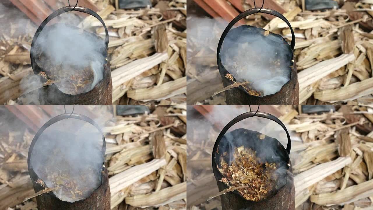 炉子里燃烧的木头冒烟，以防止蚊子和烦人的虫子。