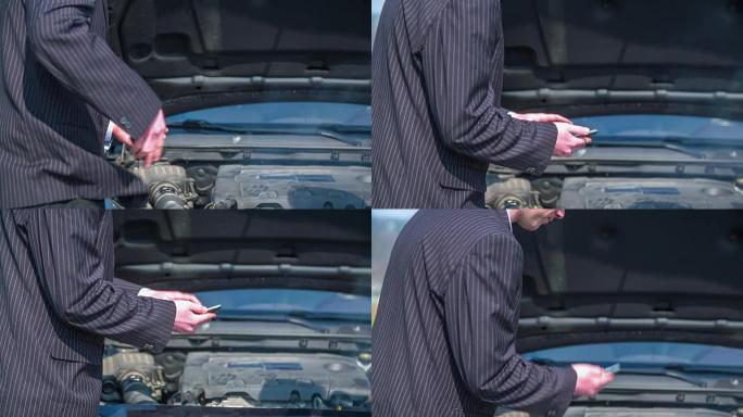 一名男子从口袋里拿出电话，因为他的坏车打电话给汽车服务，特写镜头慢动作。