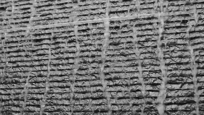 深色石头瓷砖墙上的瀑布背景