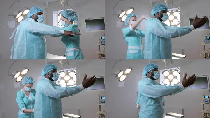 护士在外科医生身上穿无菌一次性手术服