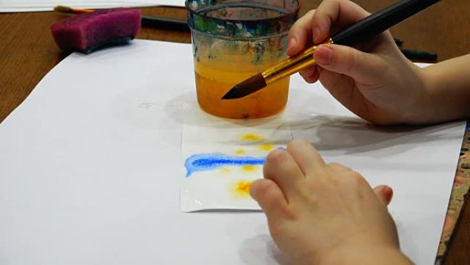 毛笔在纸上用蓝色和黄色画画