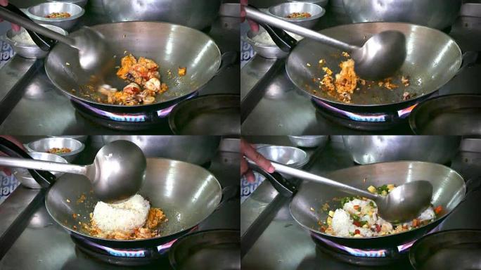 4k镜头，关闭厨师手煮泰式炒饭在旧煎锅。