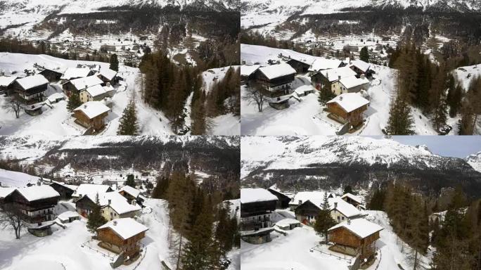 冬季空中无人驾驶飞机在冰山下的白雪皑皑的小镇和森林森林山谷上建立。户外山地自然中的雪。下飞机。探索阿