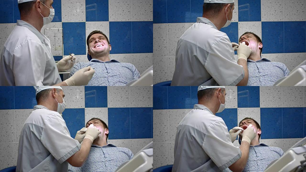 男性牙医检查其男性客户的牙齿