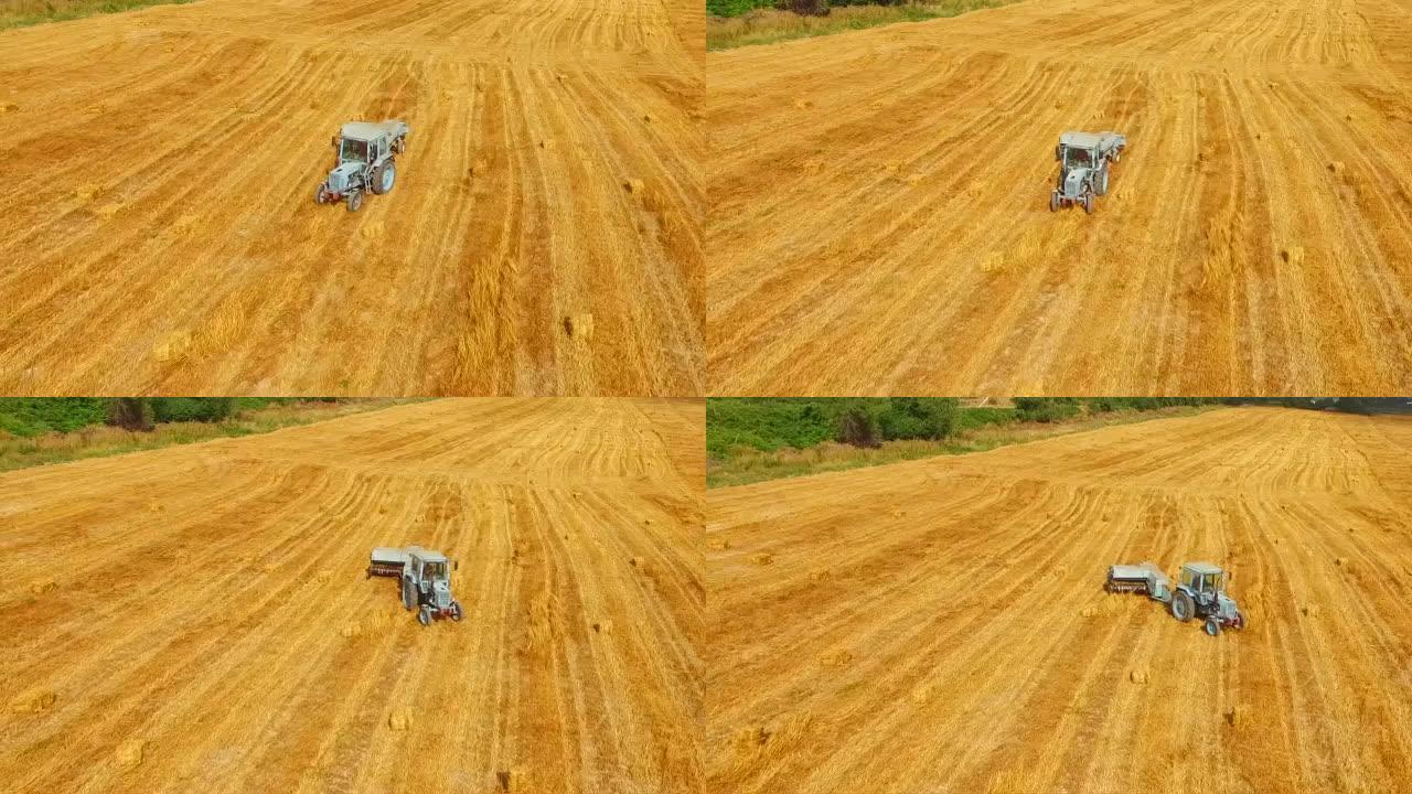 拖拉机打包机在黄茬田移动