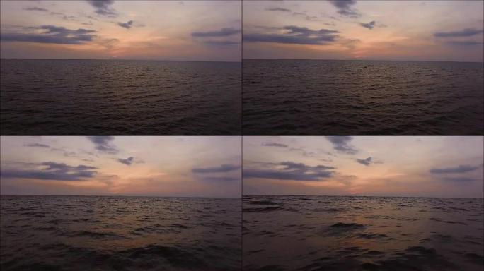 泰国湾，紫色和黄色的傍晚天空在海浪的海面上