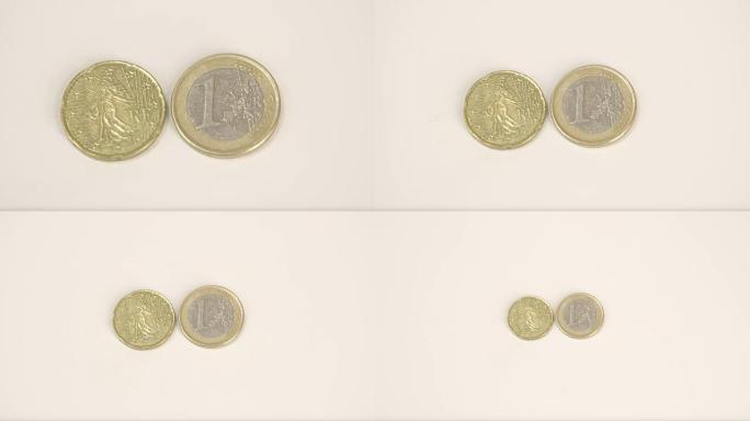 桌上有一枚镀金的法国硬币和一枚欧元硬币
