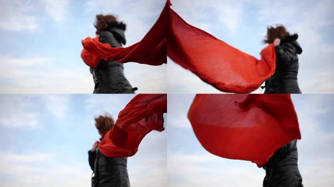 妇女在强风上握着围巾