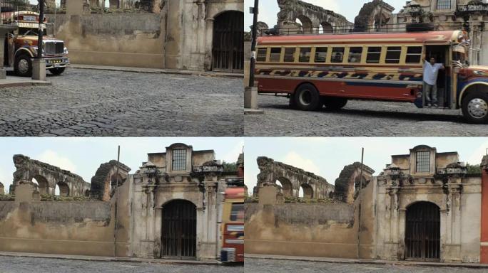 一辆古老的校车在安提瓜的一座教堂的废墟上行驶