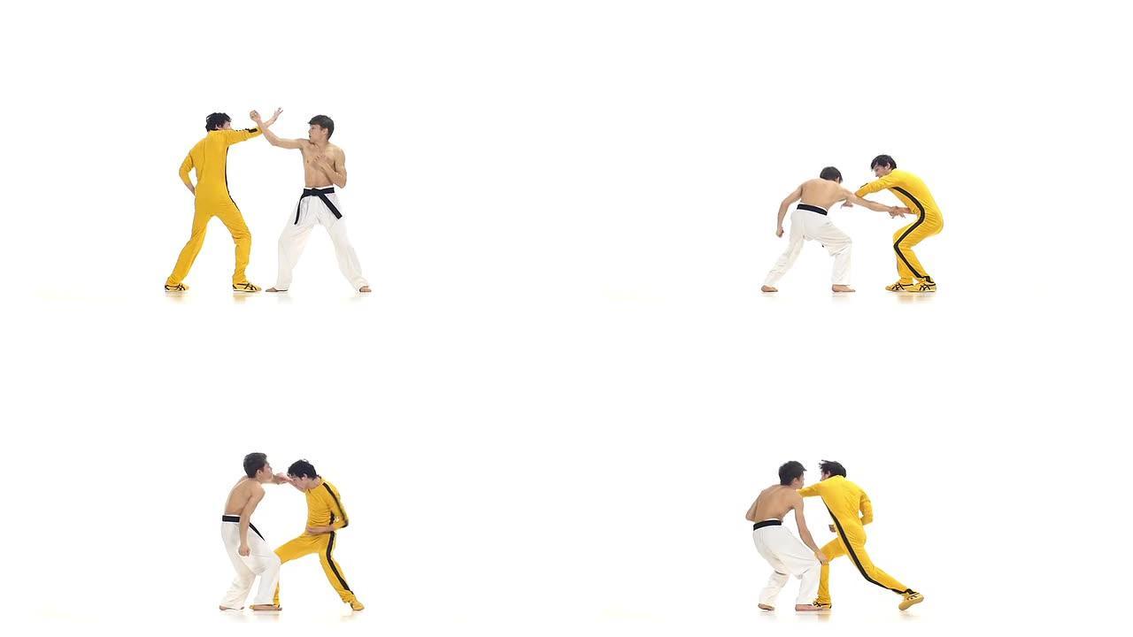 空手道和跆拳道对打:打击。慢动作，黄色衣服的空手道选手之一