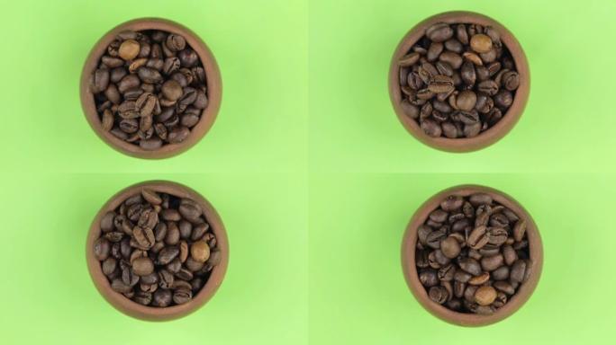 咖啡豆在绿色屏幕上隔离的锅中旋转。